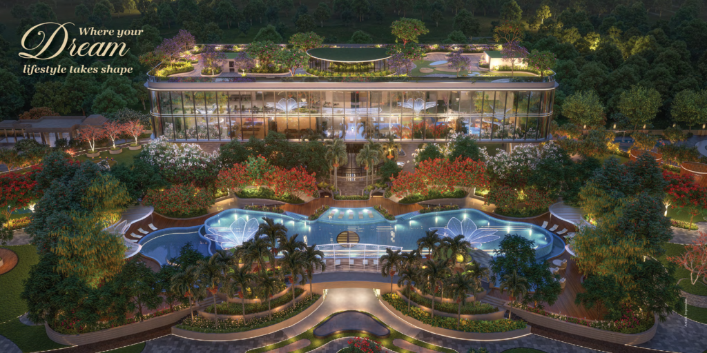 Bird's-eye view of a luxury residential complex with glass building, rooftop gardens, and a winding illuminated pool area surrounded by trees.